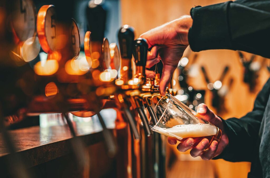 Pouring perfect gassy pints in a busy pub